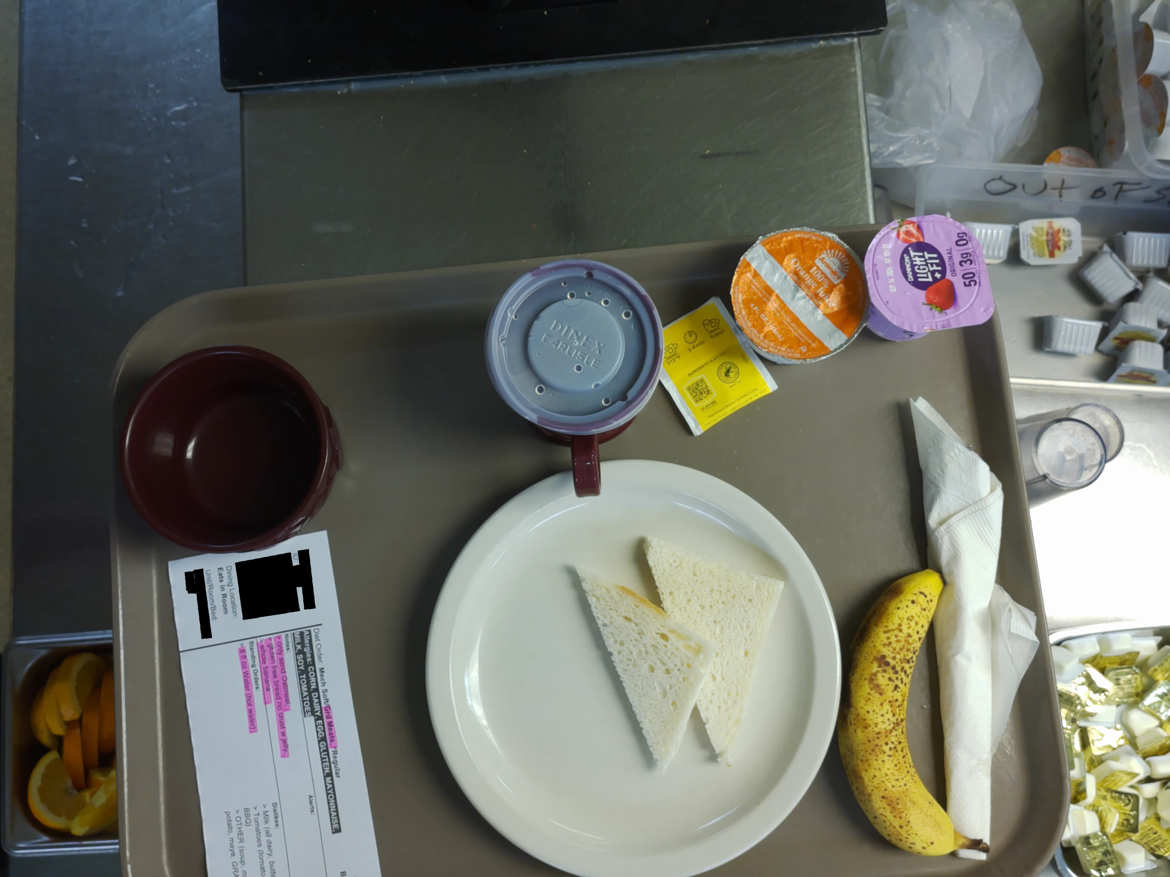 Tray photo: meal ticket and a sealed cup of Greek yogurt.