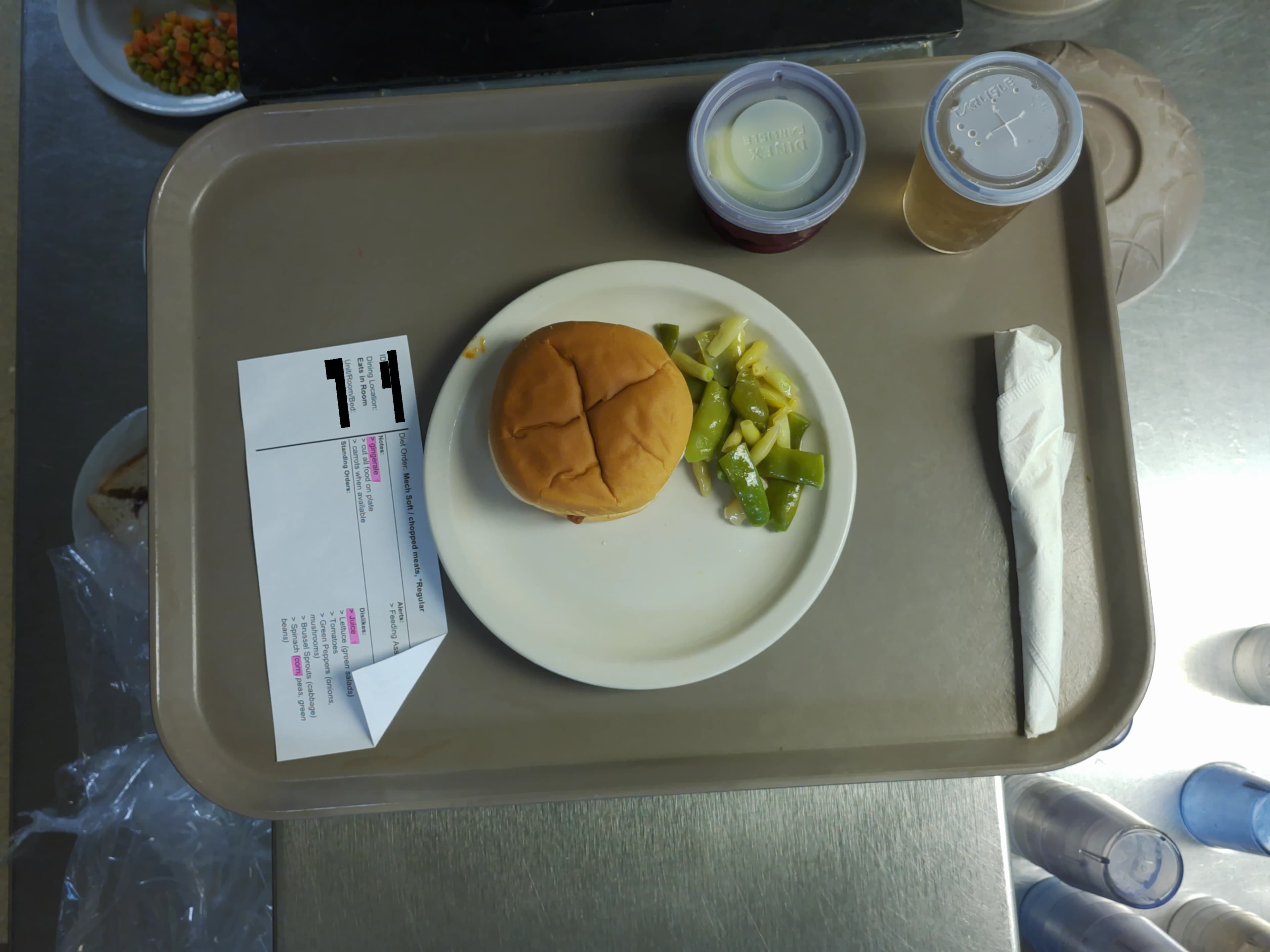 Tray photo: modified-texture ticket, an intact burger on a whole bun, and large vegetables.
